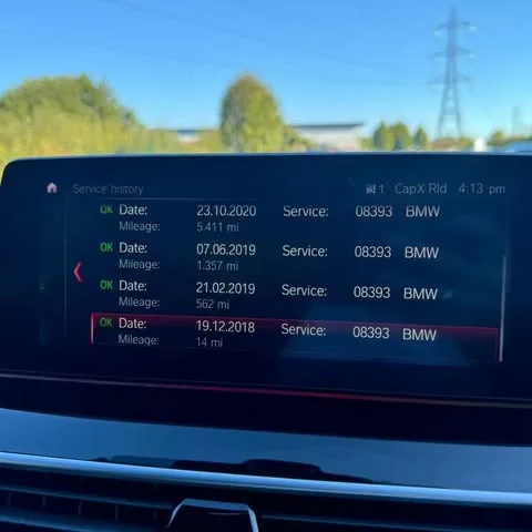 BMW iDrive screen showing updated service history entries