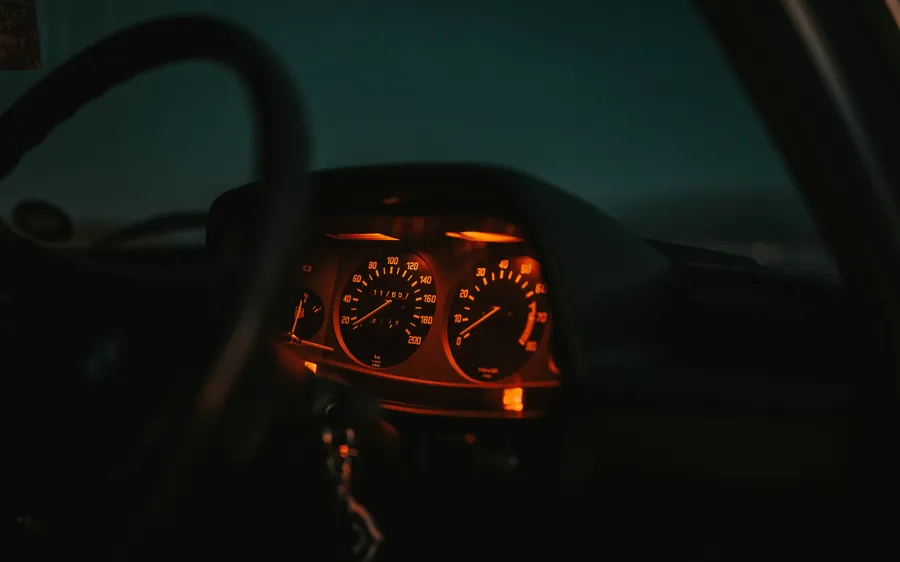 BMW dashboard lit at night with the instrument cluster glowing