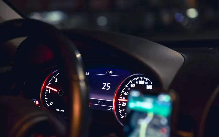 Close-up of a car speedometer at night